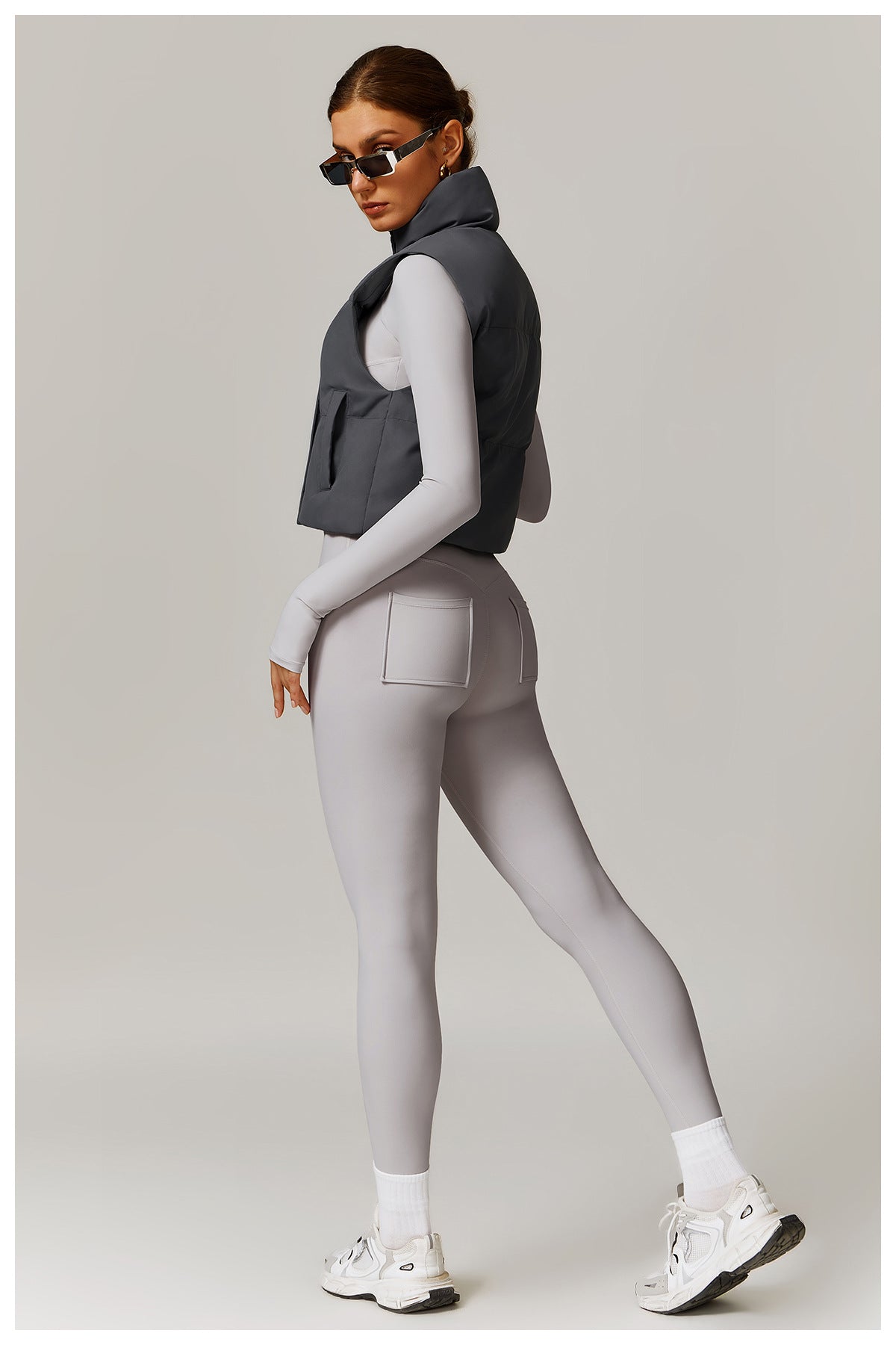 Woman’s athletic outfit featuring a stylish Winter Fashionable Warm Vest Coat for langry fashion and ملابس