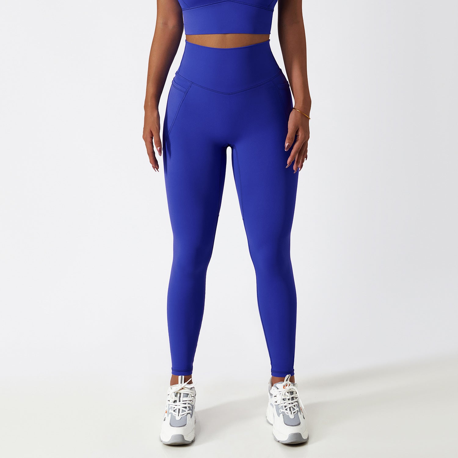 Royal blue high-waisted athletic leggings with white sneakers for fashionable fitness ملابس