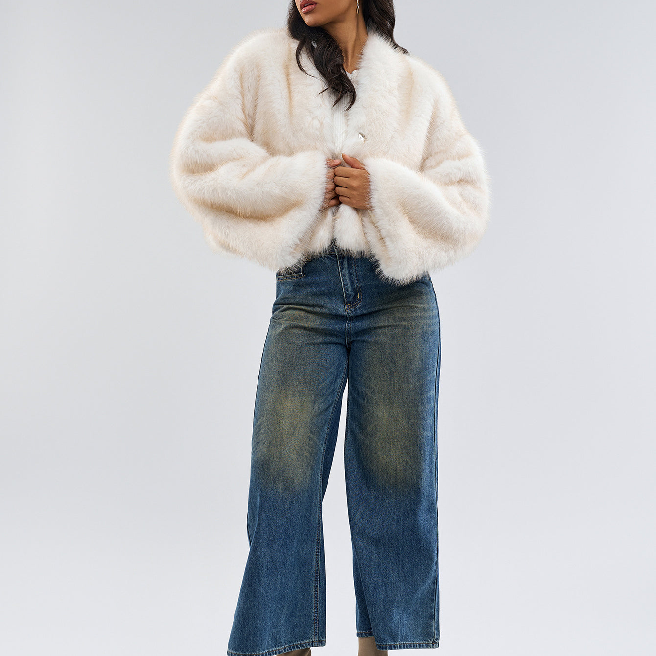 Woman in a white fuzzy coat with wide-leg jeans and tan boots showcasing Fur Short Coat fashion