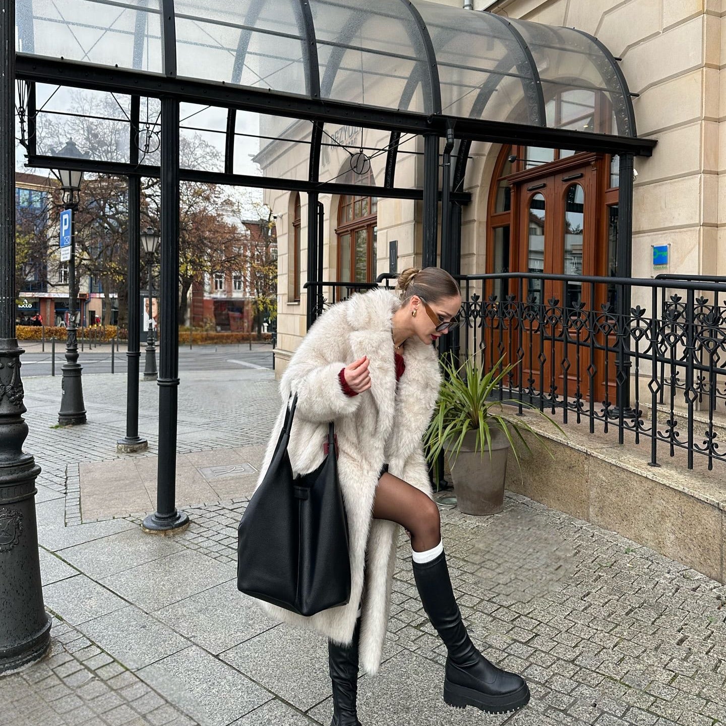 Warm faux fur coat with leather tote and knee-high boots