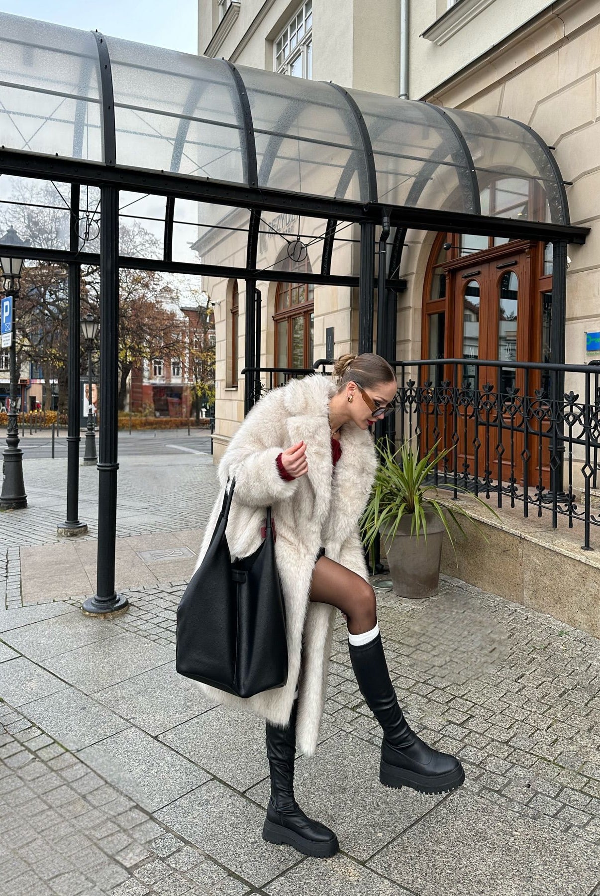 Warm faux fur coat with leather tote and knee-high boots