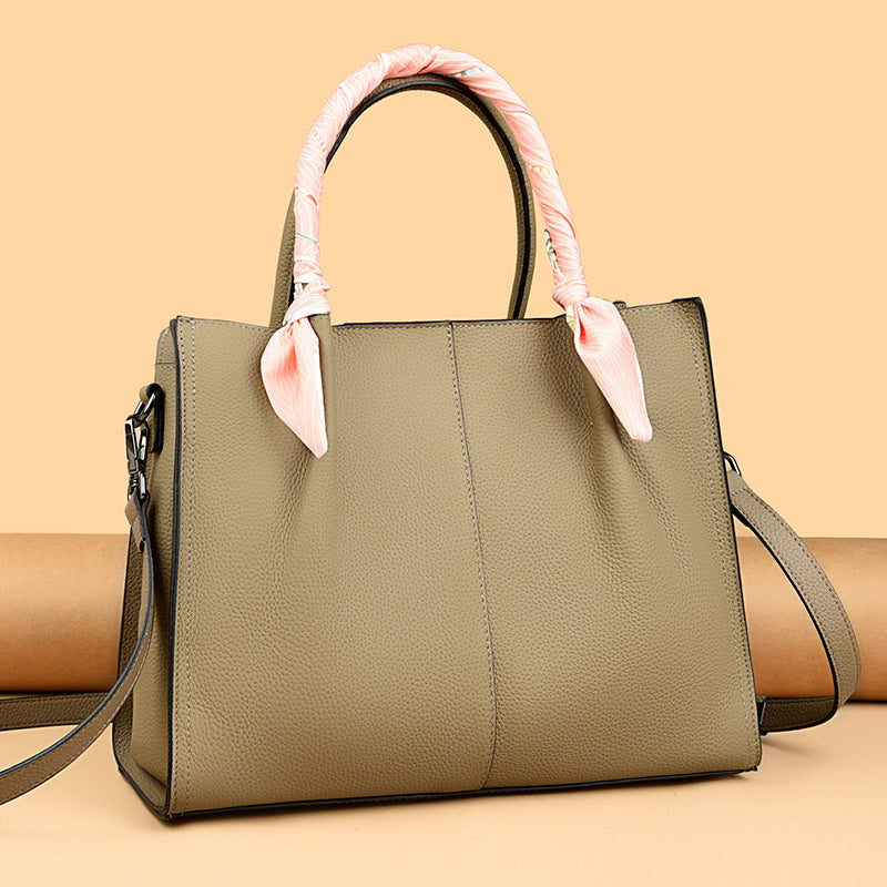 Elegant langry olive green leather handbag with bow handle and crossbody strap