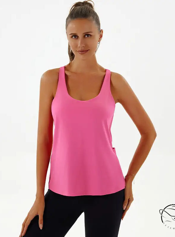 Woman in pink yoga breathable top and black leggings