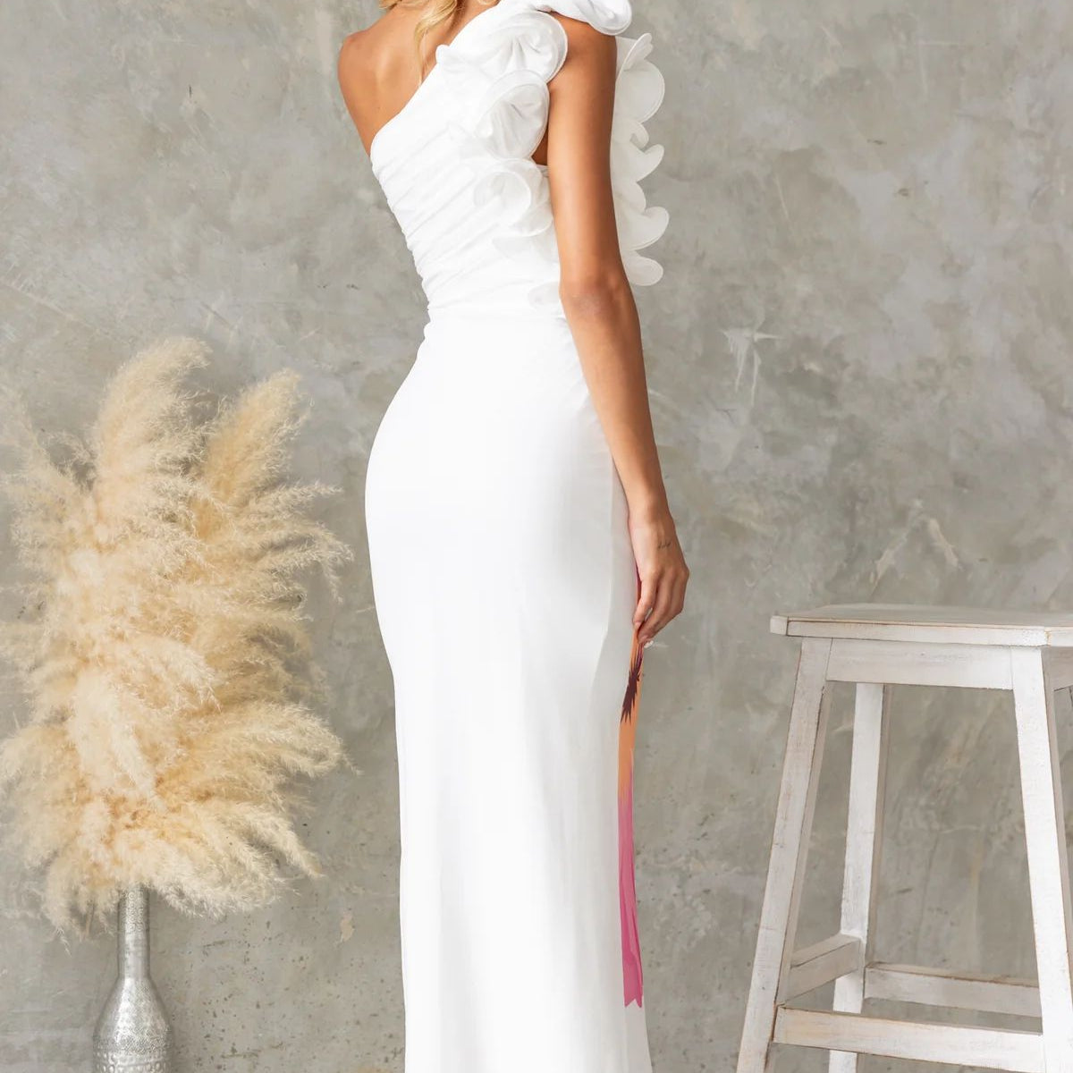 White one-shoulder ruffle dress showcasing elegant fashion style for modern ملابس lovers