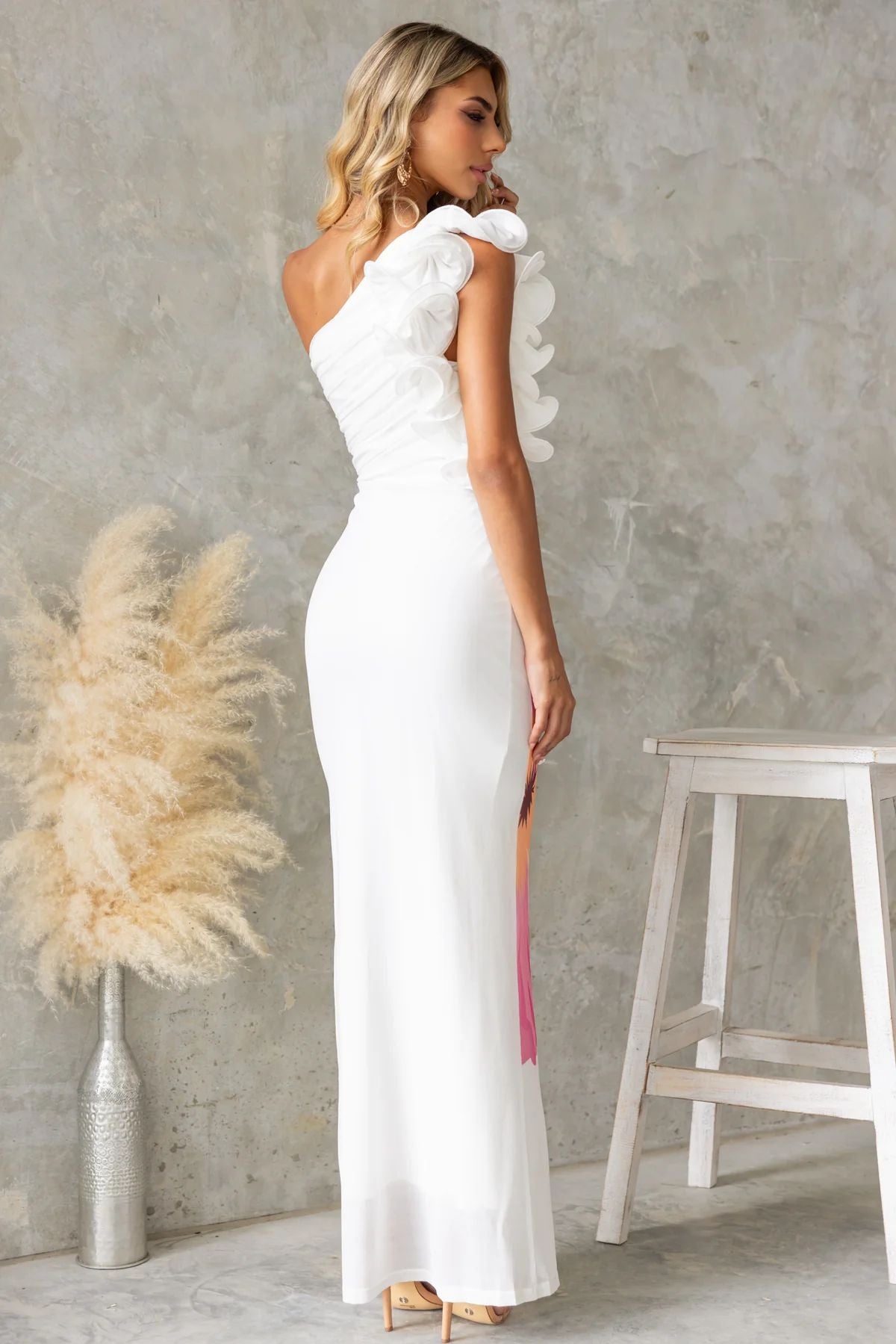 White one-shoulder ruffle dress showcasing elegant fashion style for modern ملابس lovers