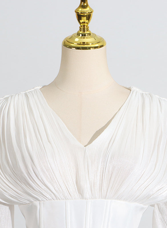 White langry pleated blouse with puff sleeves and v-neck design