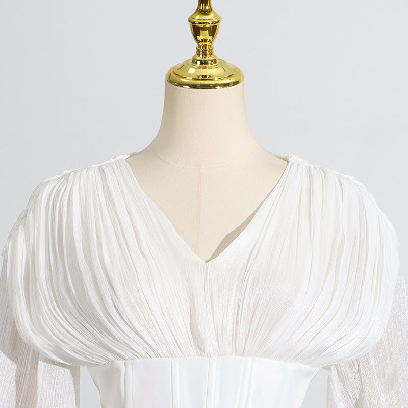 White langry pleated blouse with puff sleeves and v-neck design