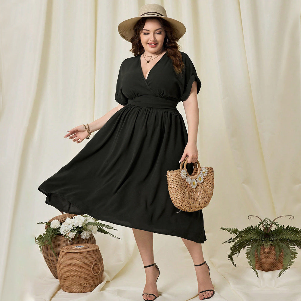 Woman in black high waist midi dress with straw hat and bag for vacation high style