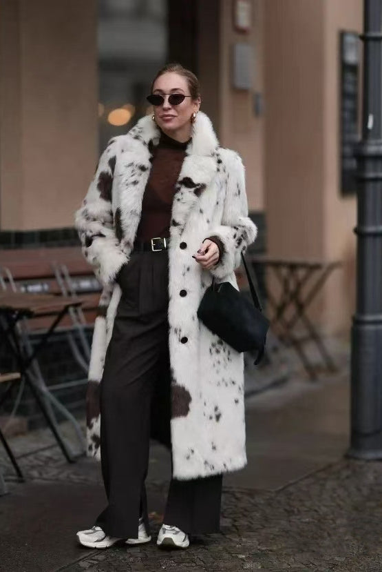 Cozy faux fur long coat in white black cow print with shearling collar