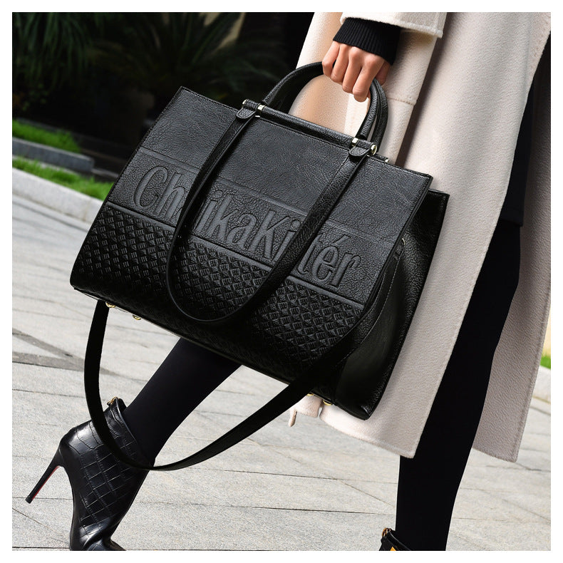 Black Calvin Klein handbag with textured pattern, perfect for fashion and ملابس enthusiasts