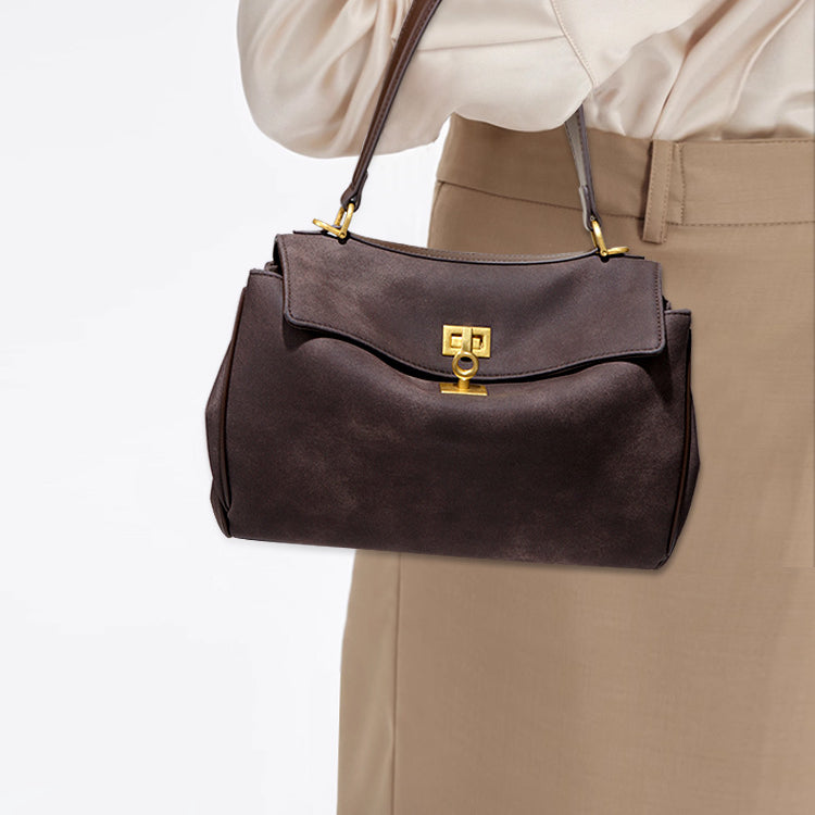 Brown leather handbag with gold hardware, perfect for stylish fashion enthusiasts