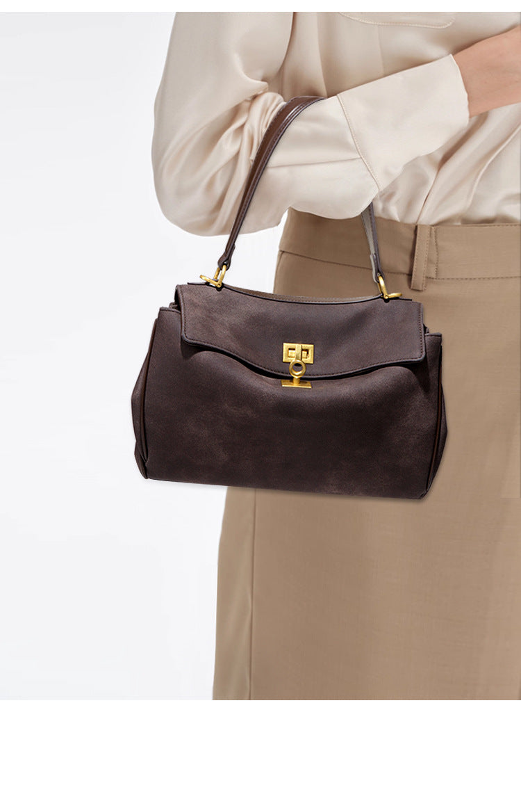 Brown leather handbag with gold hardware, perfect for stylish fashion enthusiasts