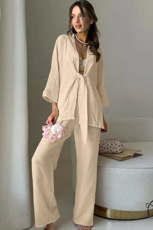 Woman in light beige winter pure cotton pajamas set with tie-front top and wide-leg pants