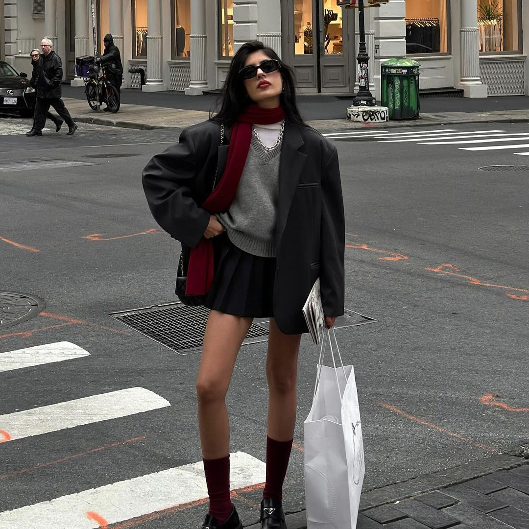 Person in winter fashion outfit with Loose Knit Vest Sweater and shopping bag