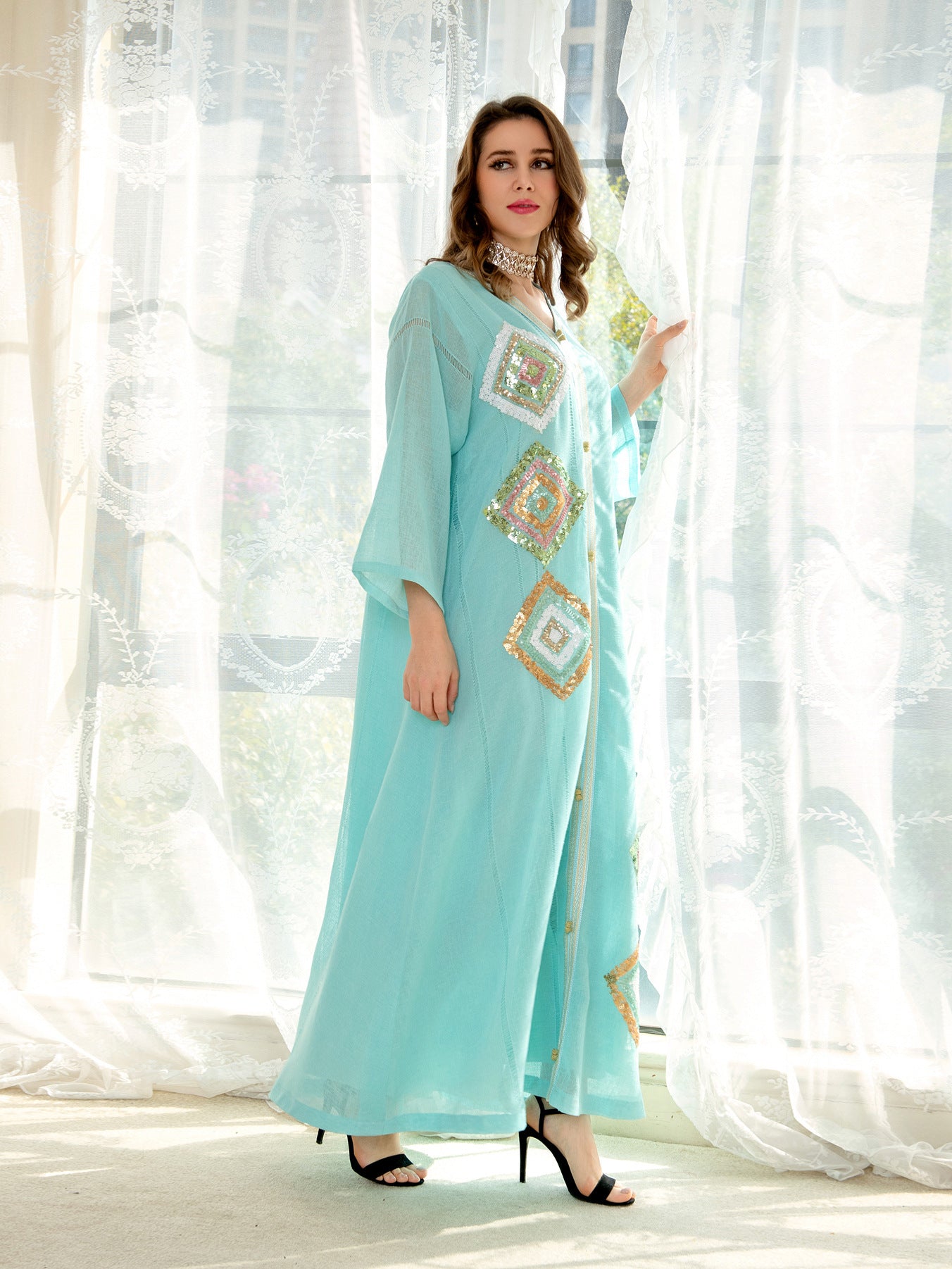 Light blue embroidered floral loose dress by Langry Fashion with gold accents, buttons, and high heels
