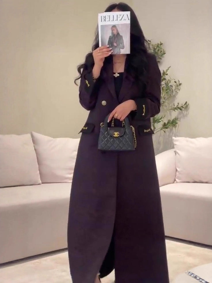 Black quilted Chanel handbag with gold hardware in Langry fashion trench coat