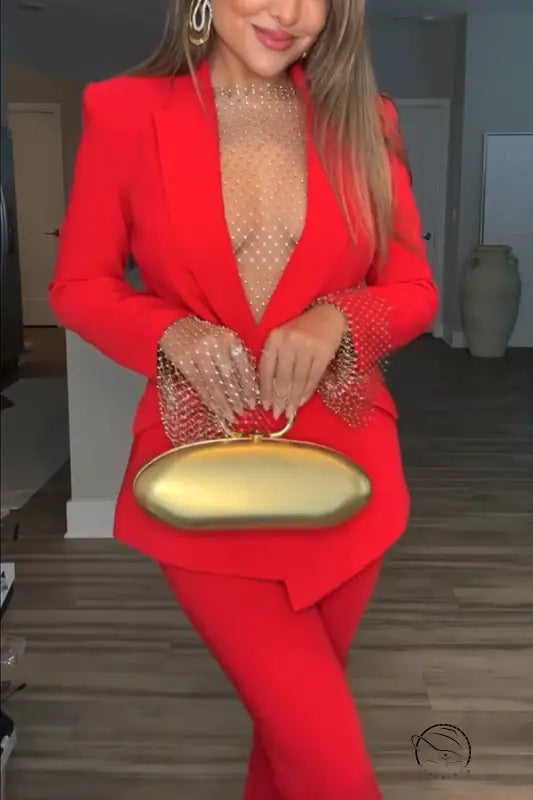 Woman in red suit with gold clutch in casual professional pants two piece set