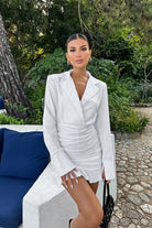 Woman in a stunning white cotton linen dress showcasing elegant fashion style