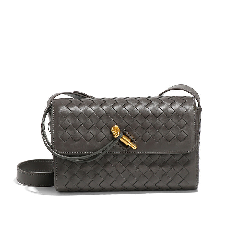 Gray woven leather crossbody bag with gold hardware, a stylish choice for modern fashion