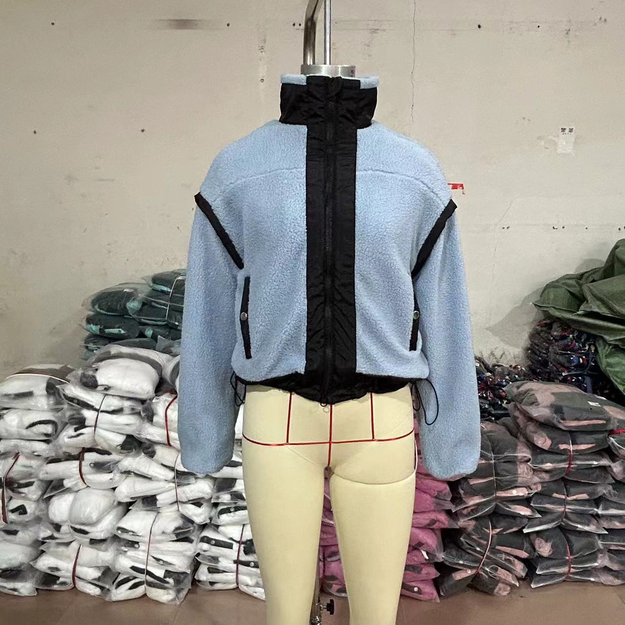 Light blue fleece jacket with black trim, ideal fashion choice for outdoor wear