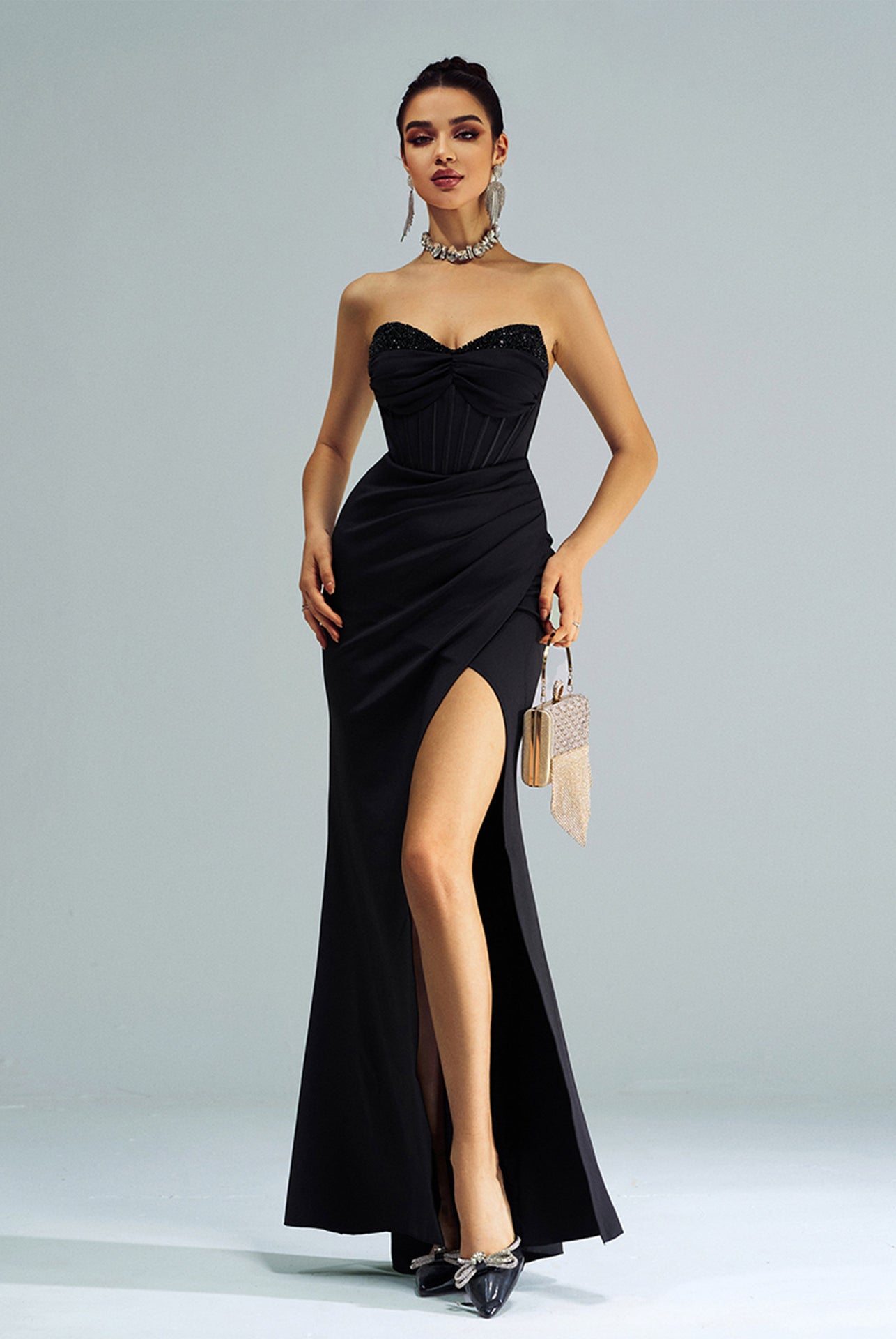 Elegant black strapless evening gown with high side slit, perfect for fashion events
