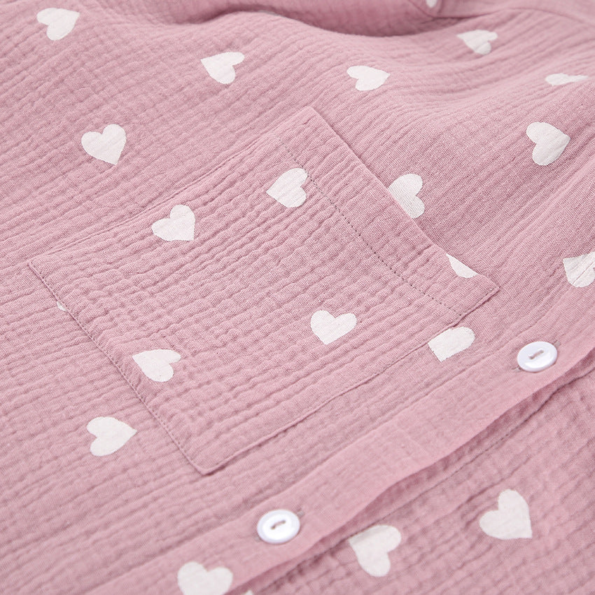 Pink crinkled fabric pajamas set with white hearts and buttons, perfect for comfortable fashion