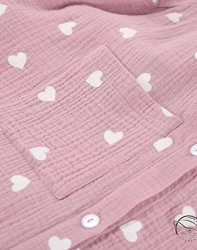 Pink crinkled cotton pajamas set with white hearts and buttons