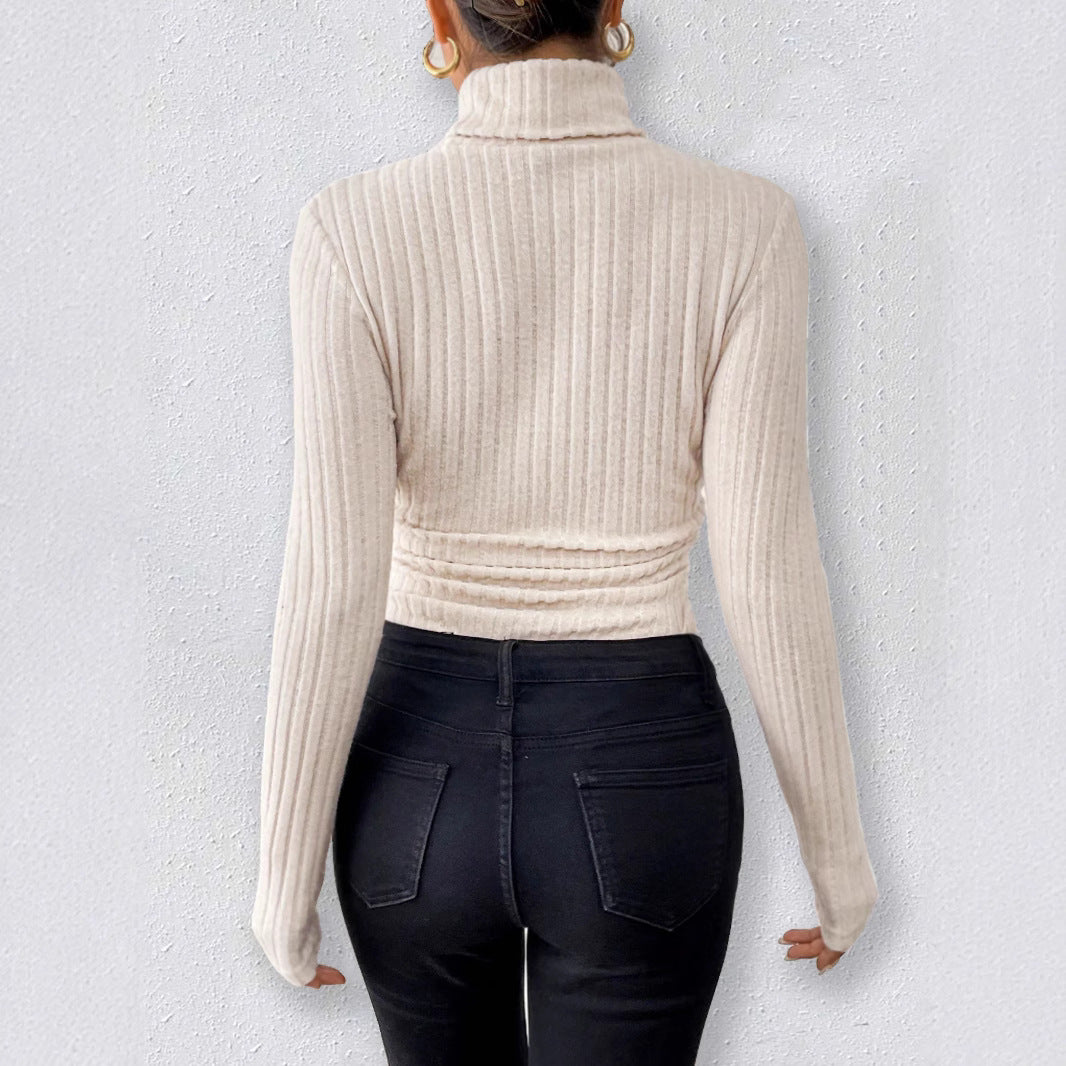 Beige ribbed long sleeve turtleneck fashion bodysuit with black jeans and gold hoops