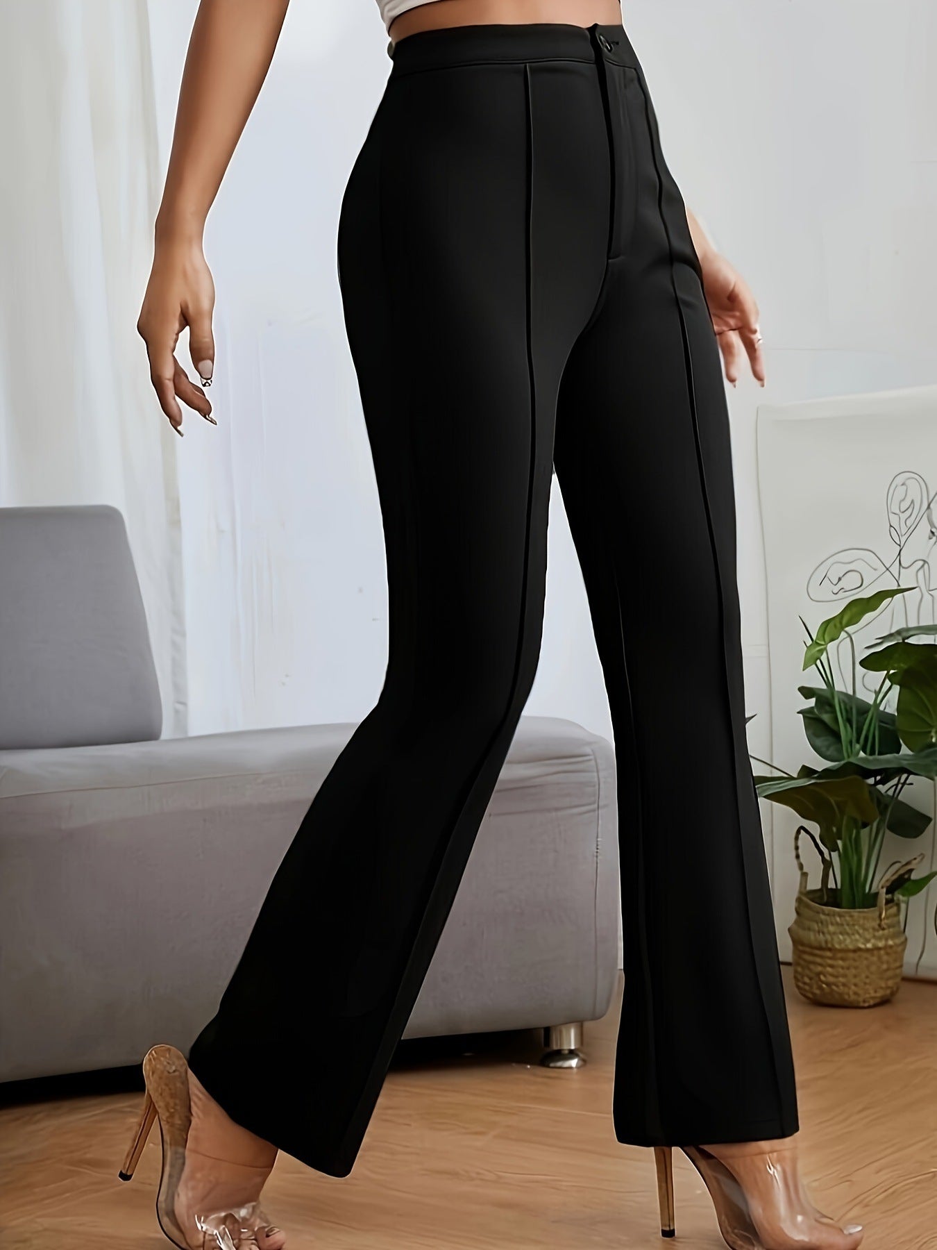 Black high-waisted flared dress pants showcasing a sleek silhouette in fashion ملابس