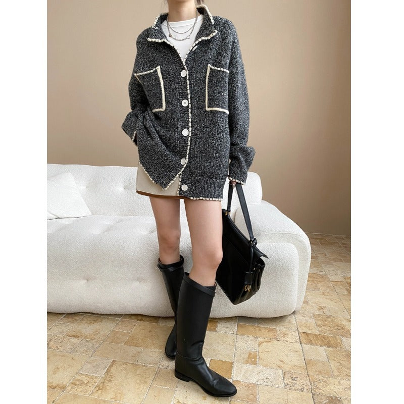 Fashionable double pocket loose knitted sweater coat with white piping and black leather skirt