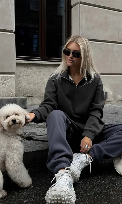 Woman in autumn winter fleece lined half zipper sweater with dog