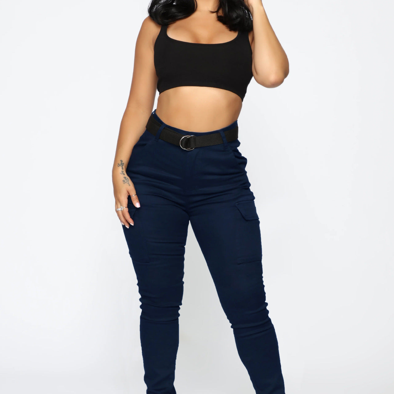 Woman wearing casual skinny stretch belt sports pants with black crop top