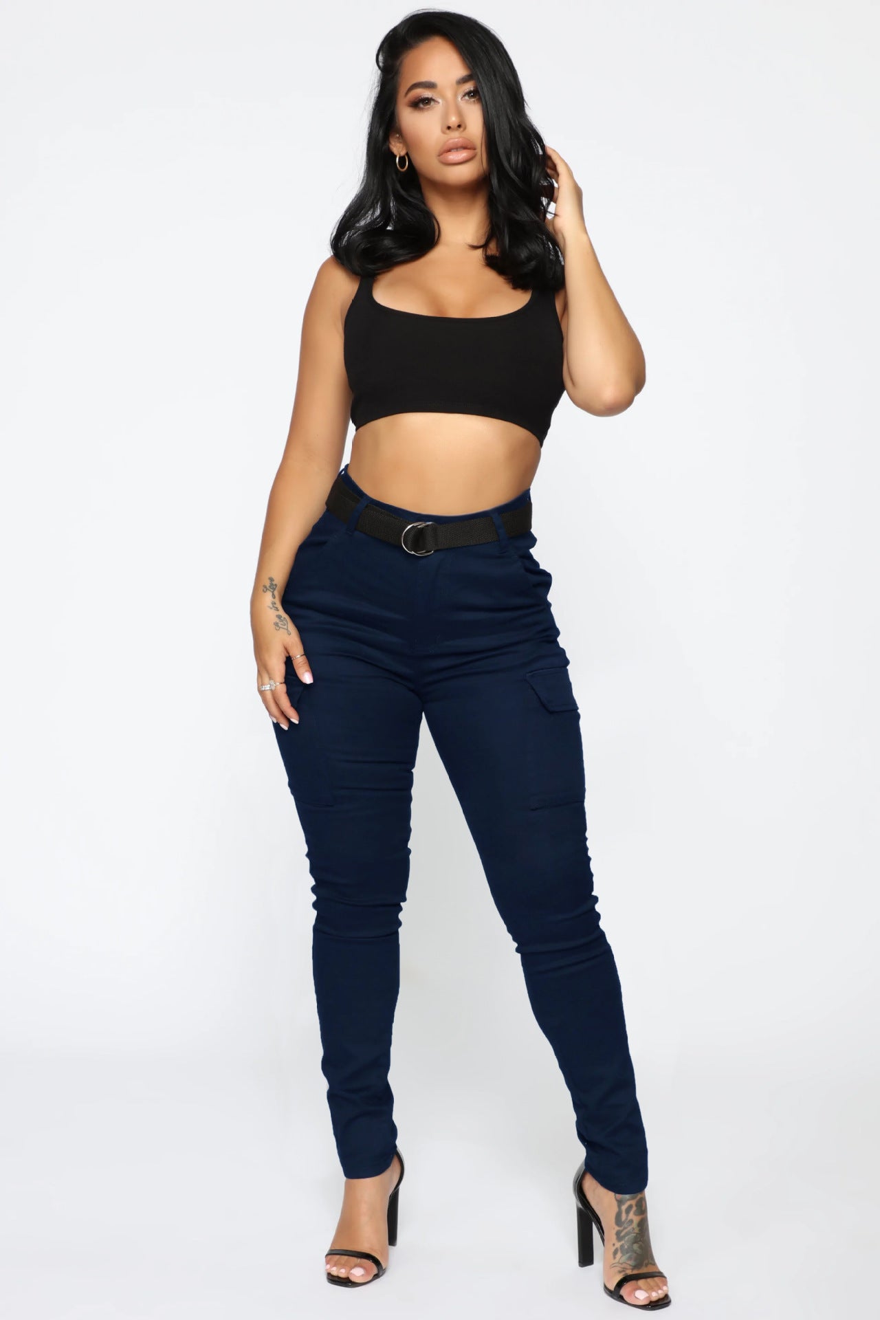 Woman wearing casual skinny stretch belt sports pants with black crop top