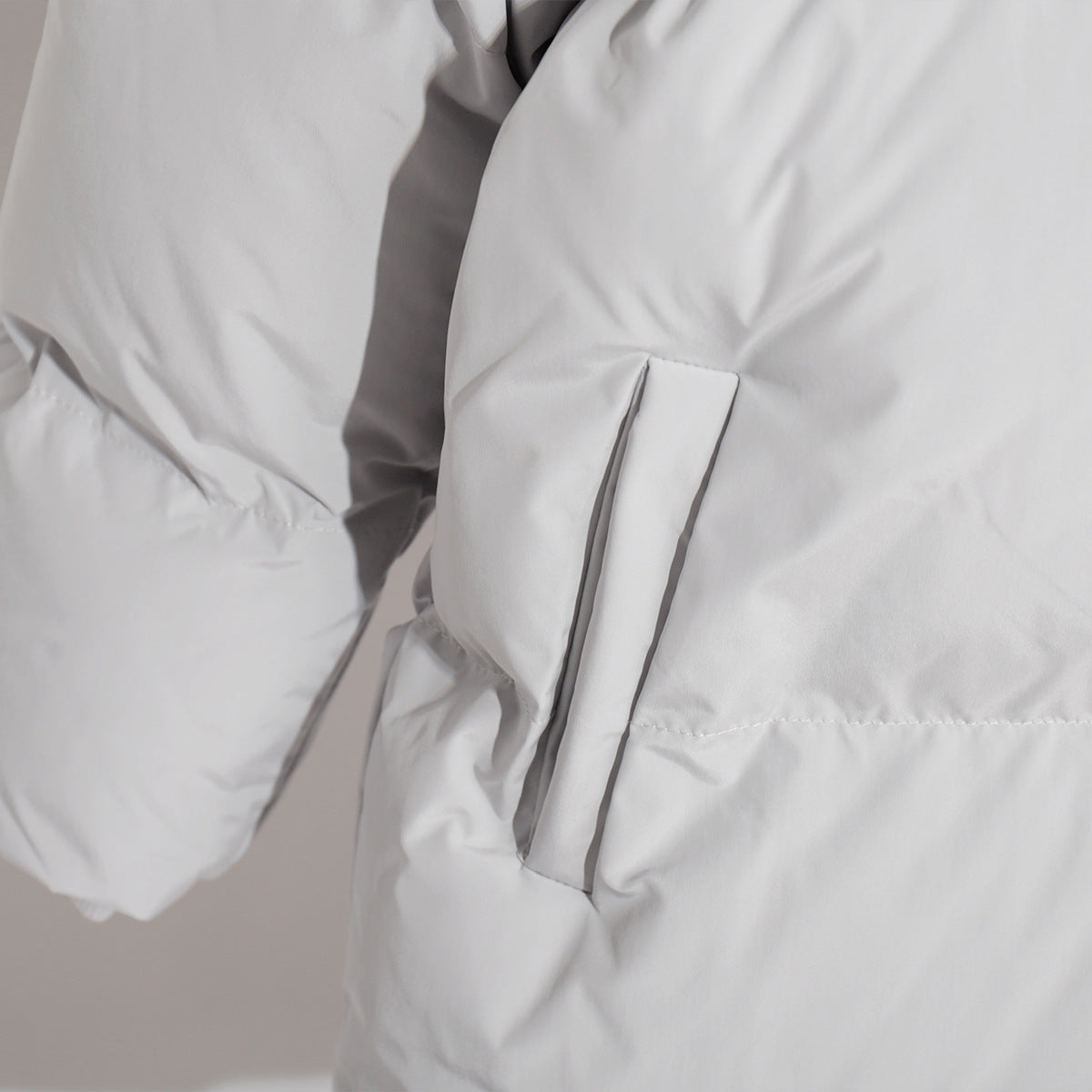 Detail of a White Puffer Jacket from the Cotton Coat Jacket collection in fashion ملابس