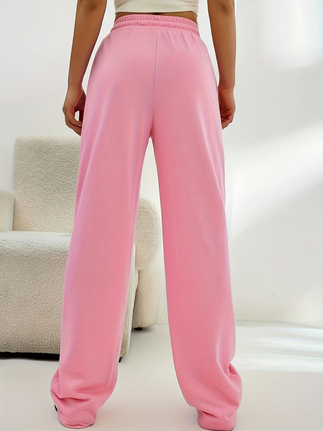 Pink wide-leg sweatpants with elastic waistband, ideal for casual fashion and comfort