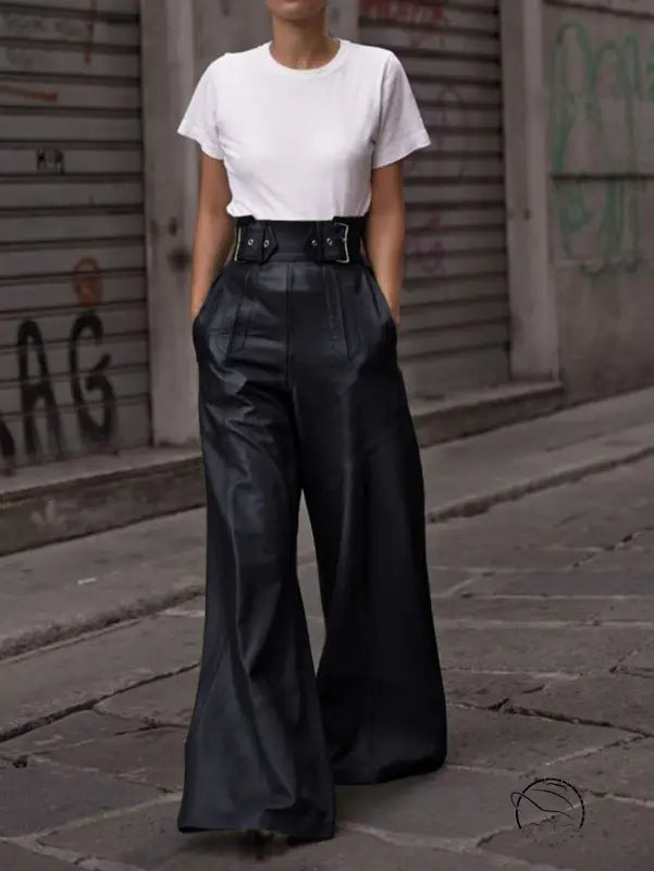 Person in white t-shirt and high-waist faux leather bell bottom pants