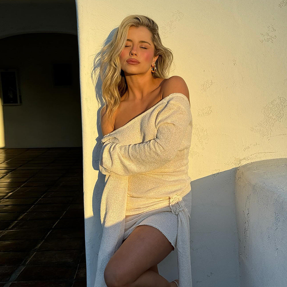 Blonde woman in off-shoulder knitted long-sleeved dress showcasing elegant fashion gear