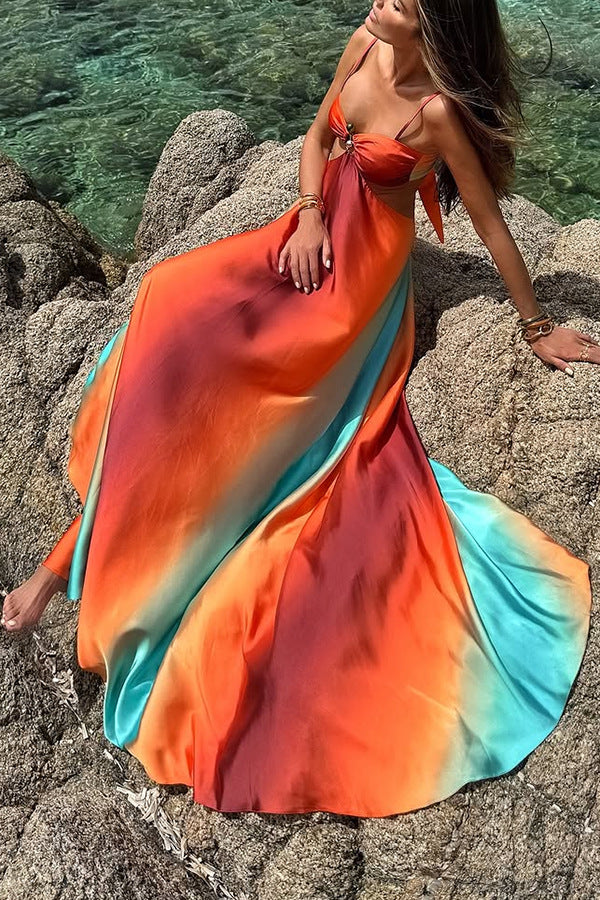 Flowing maxi dress in vibrant orange, red, and turquoise ombré for stylish beach fashion