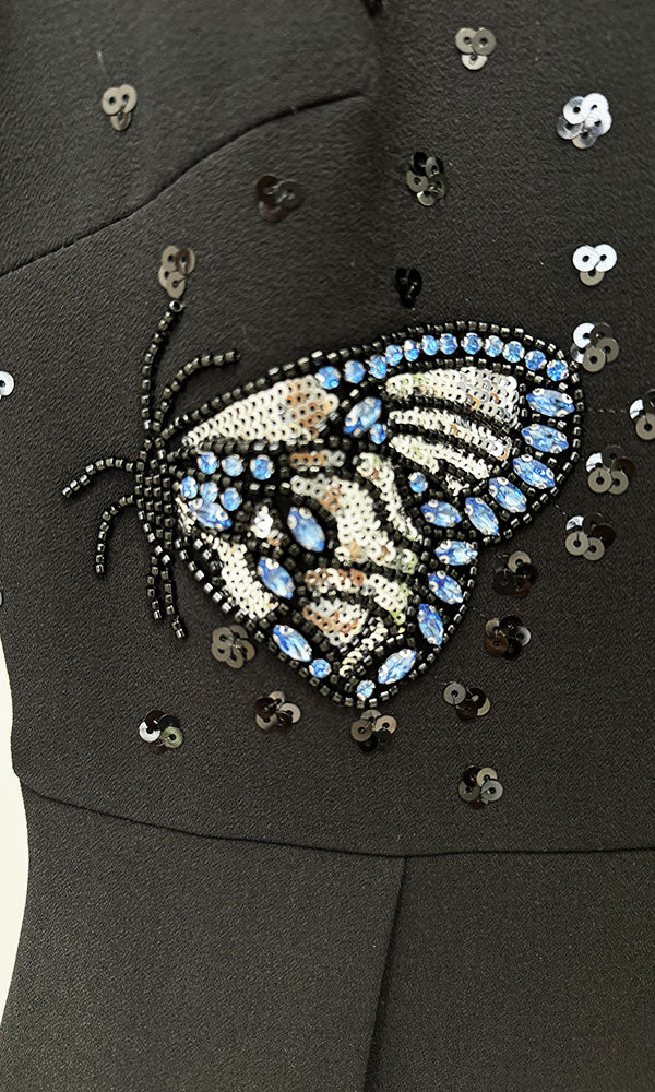 Black dress with beaded butterfly design, perfect for elegant fashion occasions in ملابس