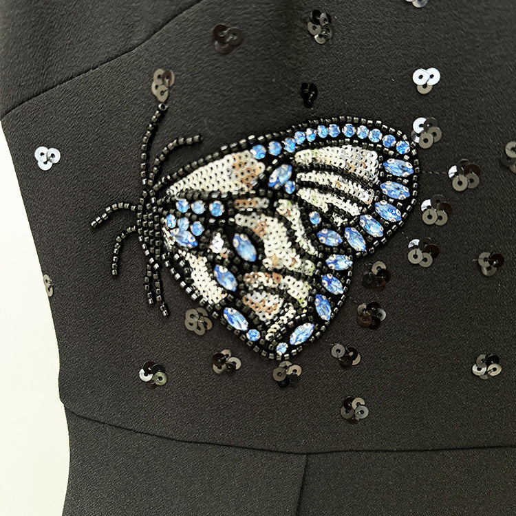 Black dress with beaded butterfly design, perfect for elegant fashion occasions in ملابس