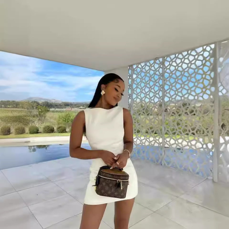 Sleeveless white mini dress with brown Louis Vuitton handbag for stylish fashion ملابس