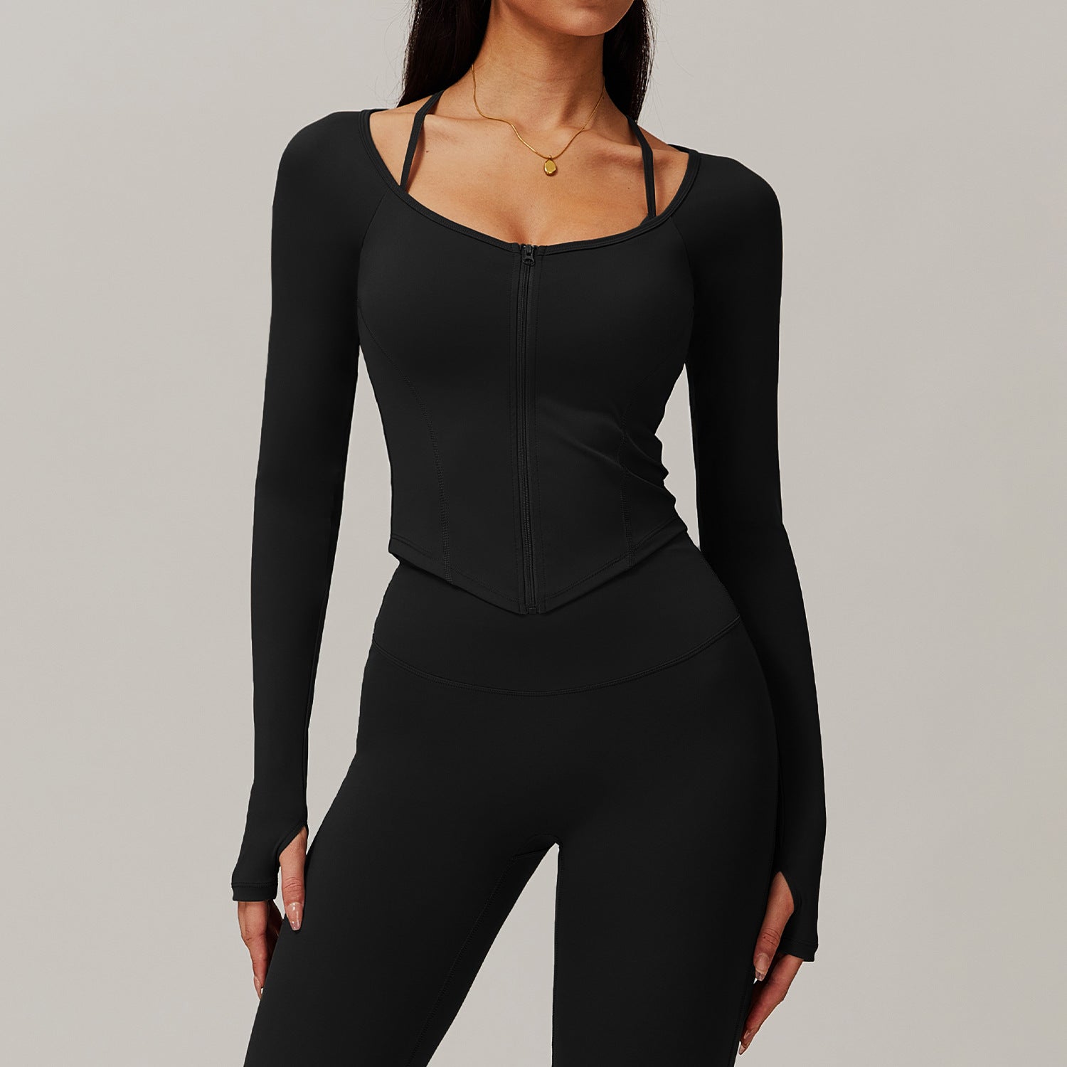 Black long-sleeved athletic bodysuit with leggings, ideal for comfortable yoga fashion