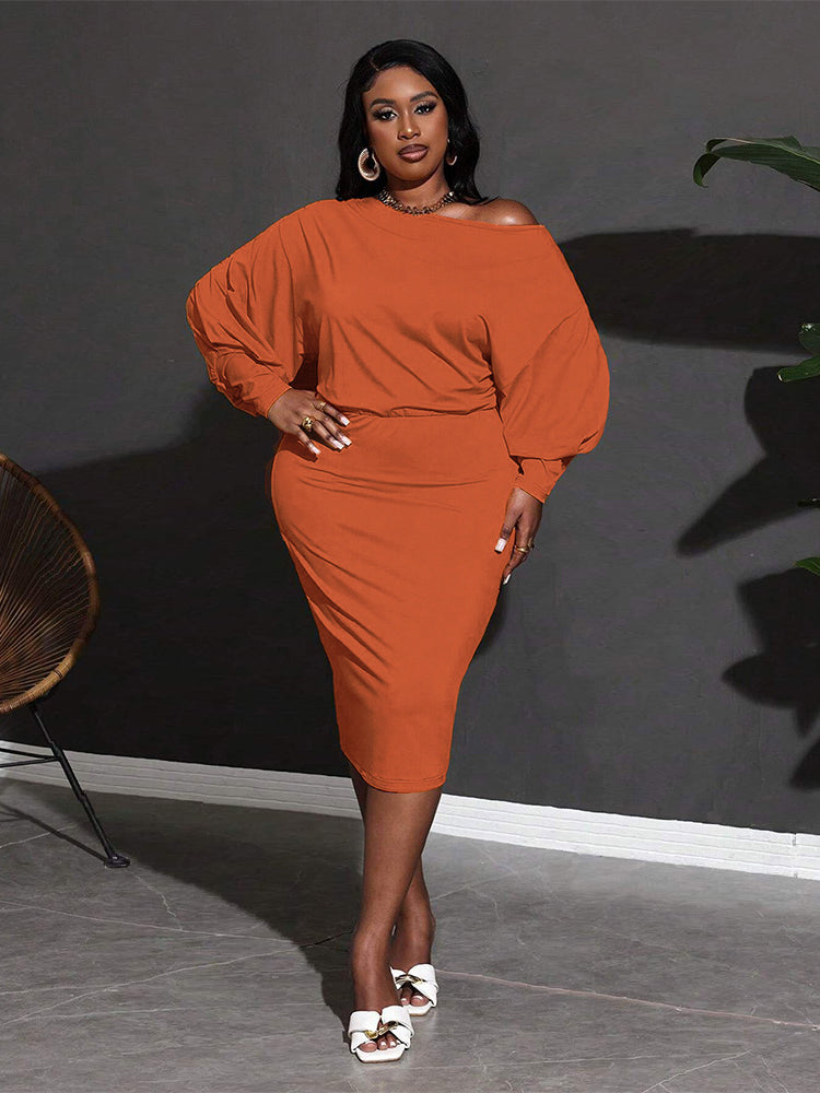 Woman in orange dress showcasing the Classic Mid Length Dress in stylish fashion ملابس