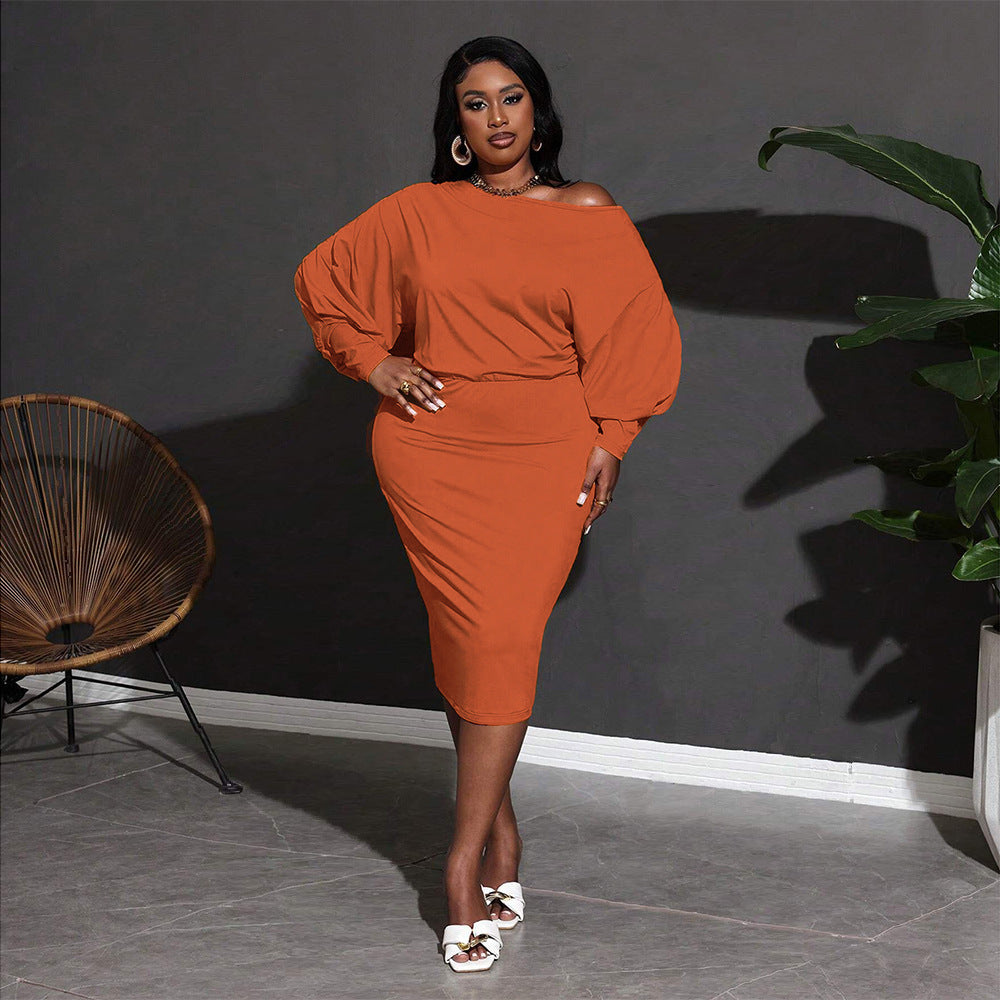 Woman in orange dress showcasing the Classic Mid Length Dress in stylish fashion ملابس