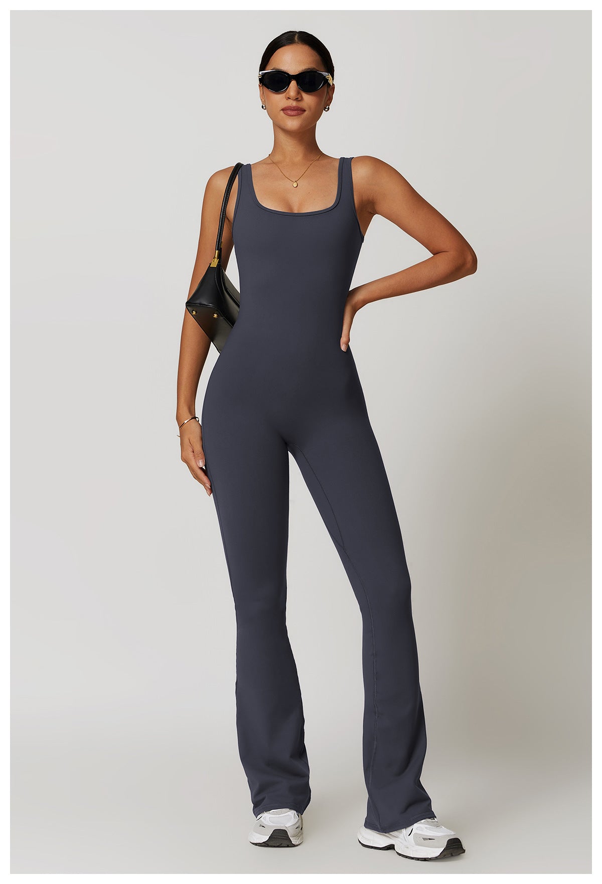 Sleeveless charcoal gray fitted jumpsuit with flared legs for active fashion wear