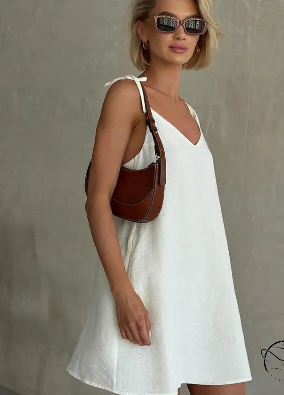 Woman in casual backless cotton home wear with short blonde hair