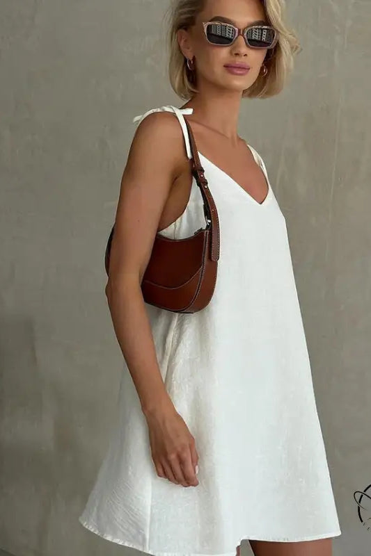 Woman in casual backless cotton home wear with short blonde hair