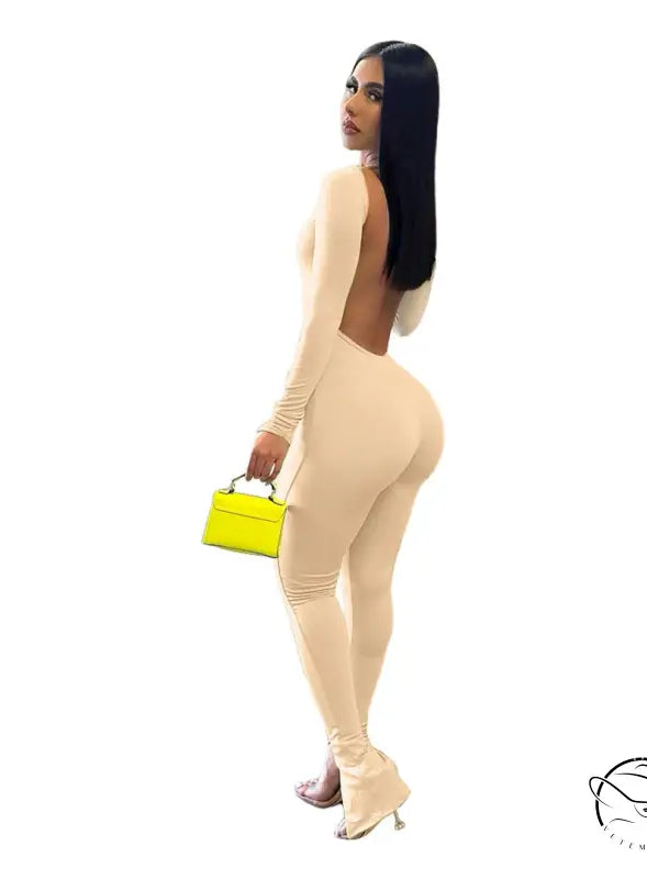 Elegant backless slit jumpsuit in beige with yellow purse