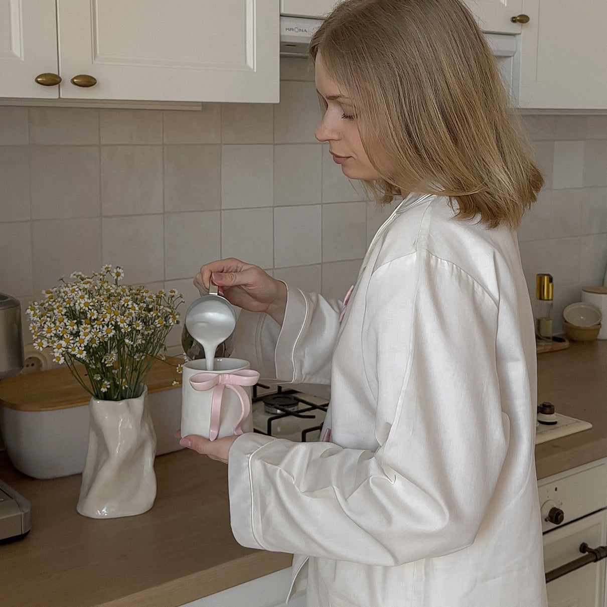 Elegant white ceramic vase with floral arrangement in Langry fashion pajamas display