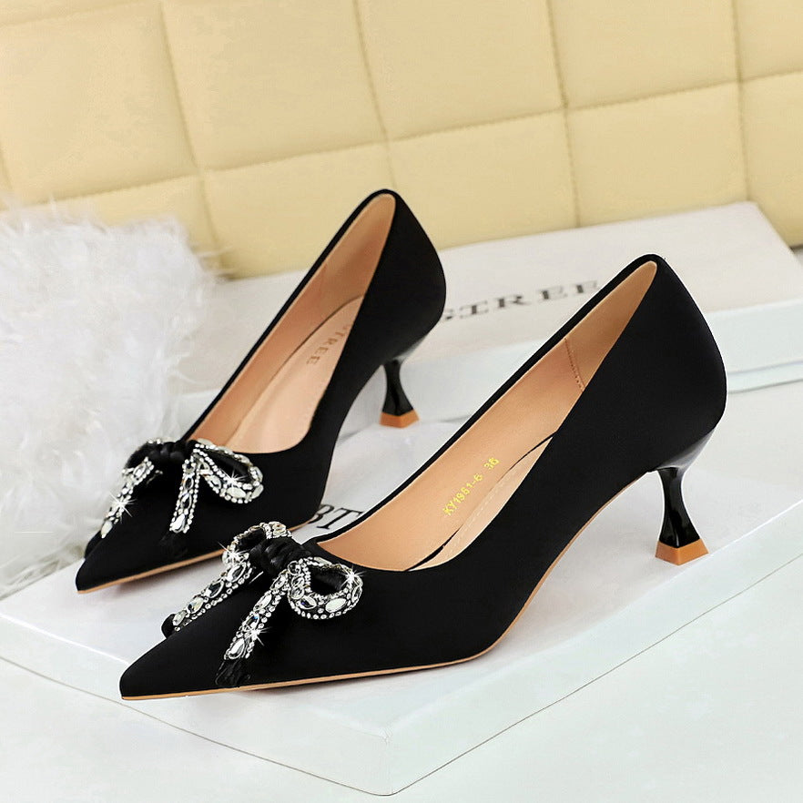 Elegant Langry black satin stilettos with rhinestone bows and gold tips